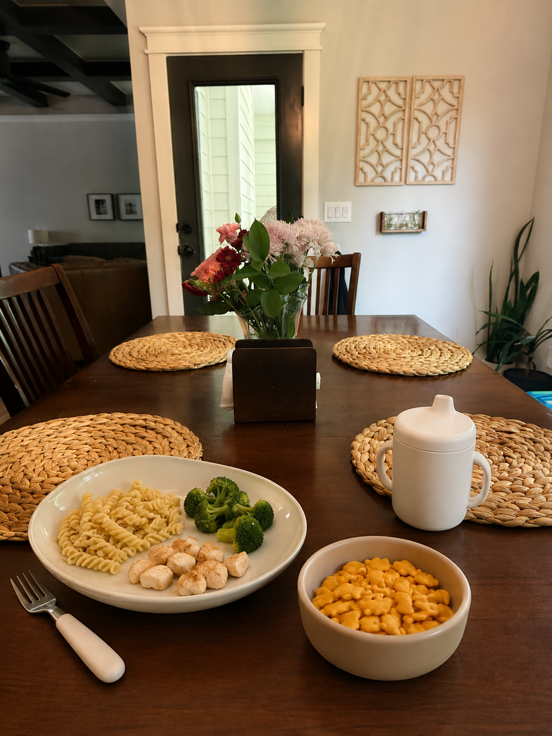 Toddler dinner plate with untouched food beside a small afternoon snack, illustrating why children may eat snacks but refuse dinner.